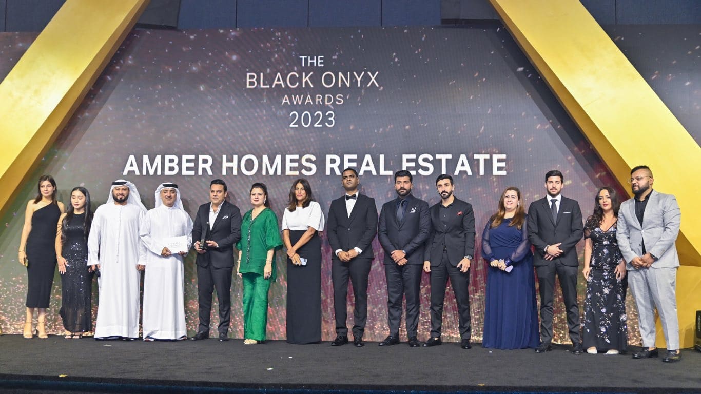 Amber Homes Real Estate team receiving Platinum Agency 2023 from Meraas, Nakheel & Dubai Holding