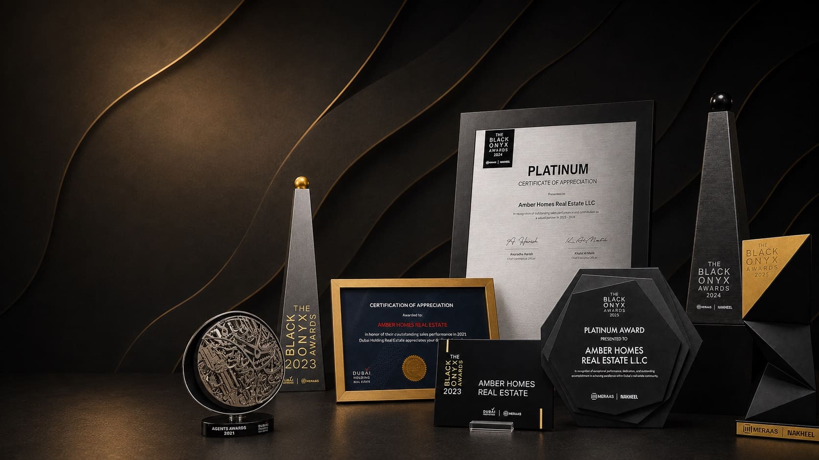 Amber Homes Real Estate award collection — Platinum Agency trophies and certificates for Meraas, Nakheel & Dubai Holding, alongside earlier developer recognition